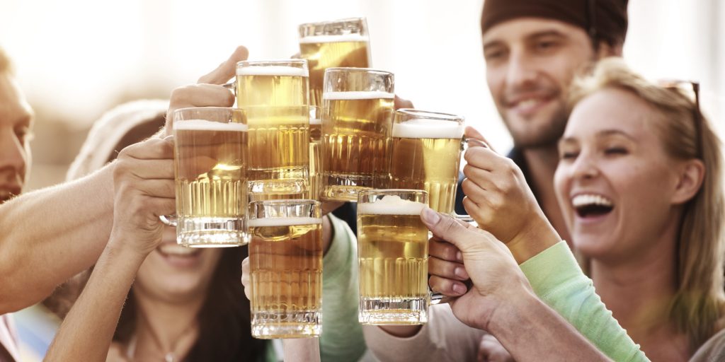 Young people at bistro having beer